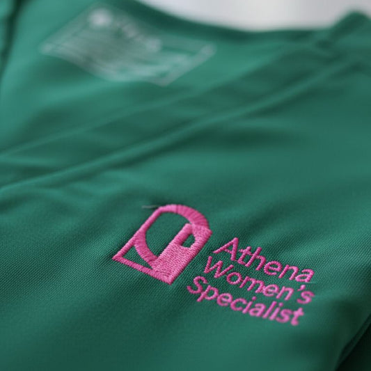 Green shirt with 'Athena Women's Specialist' logo on a white background