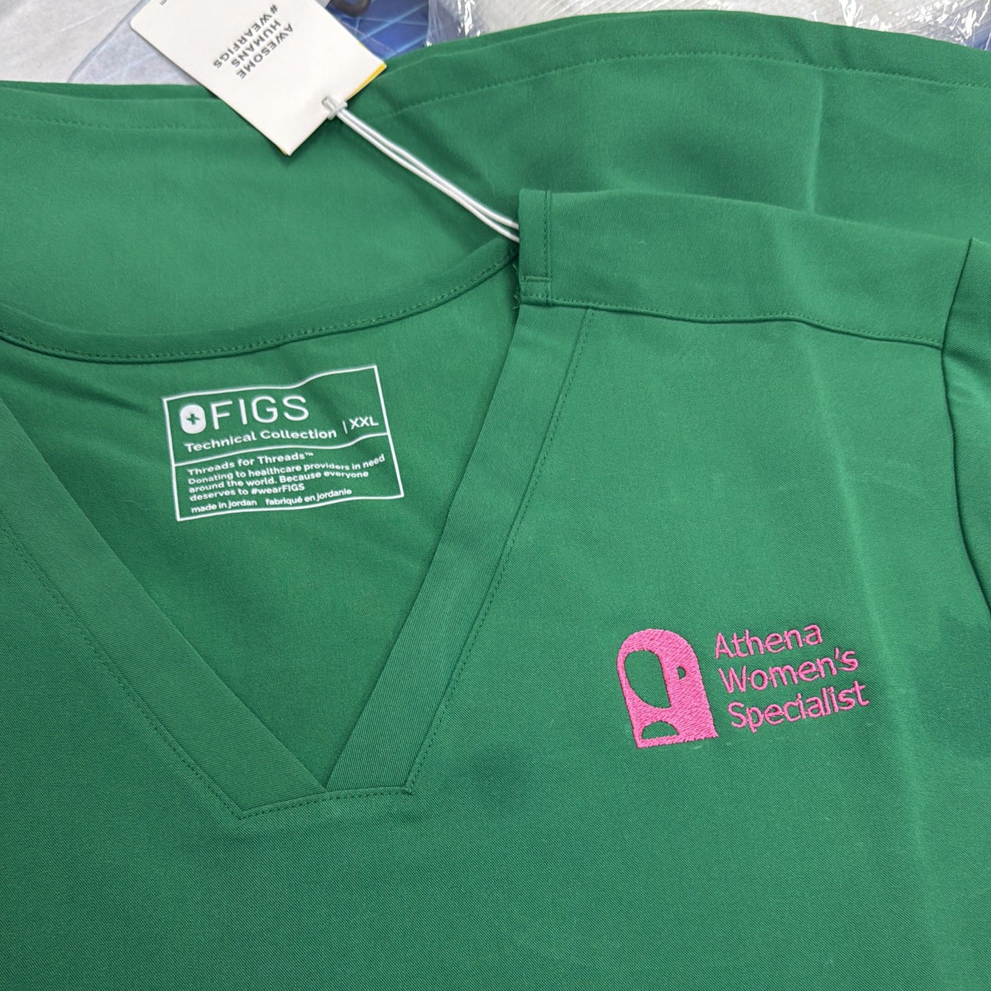 Green polo shirt with a brand logo embroidered on a white background