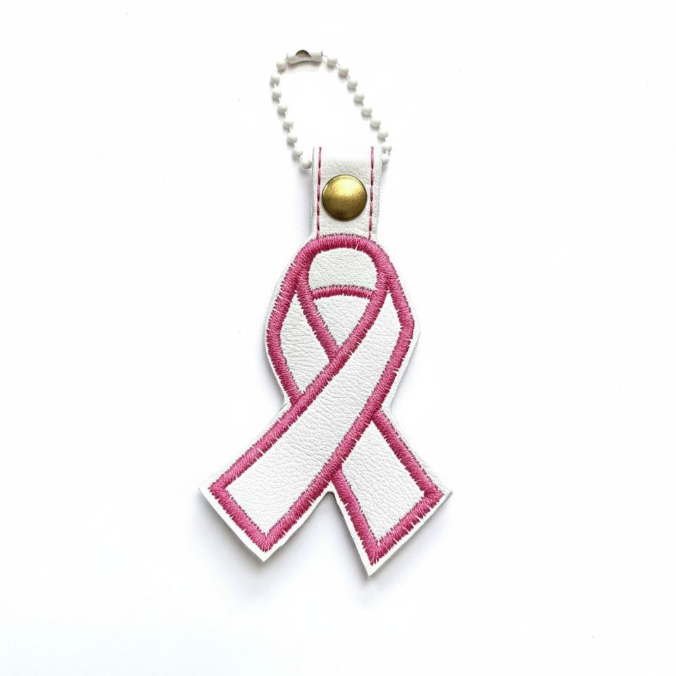 Pink and white ribbon keychain on a white background